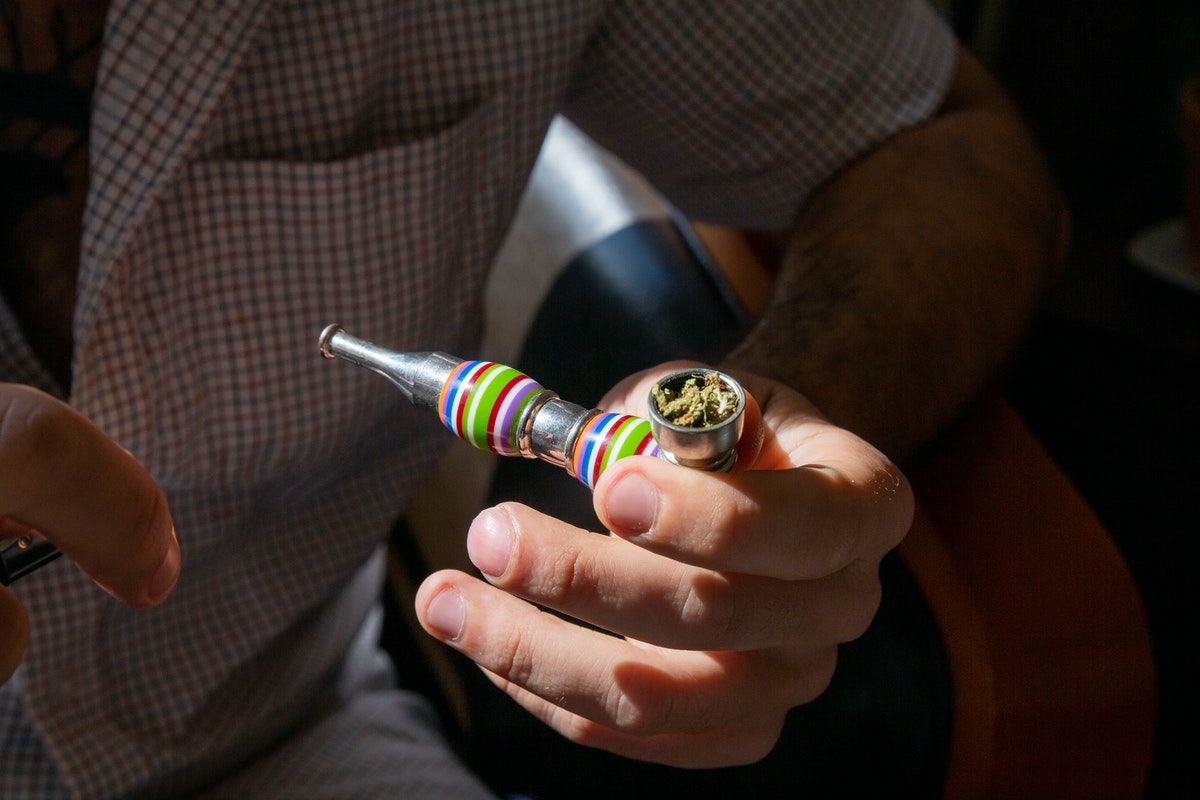 man smoking from a pipe